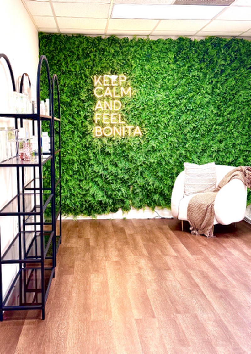 Greenery wall and seating at The Body Temple Spa