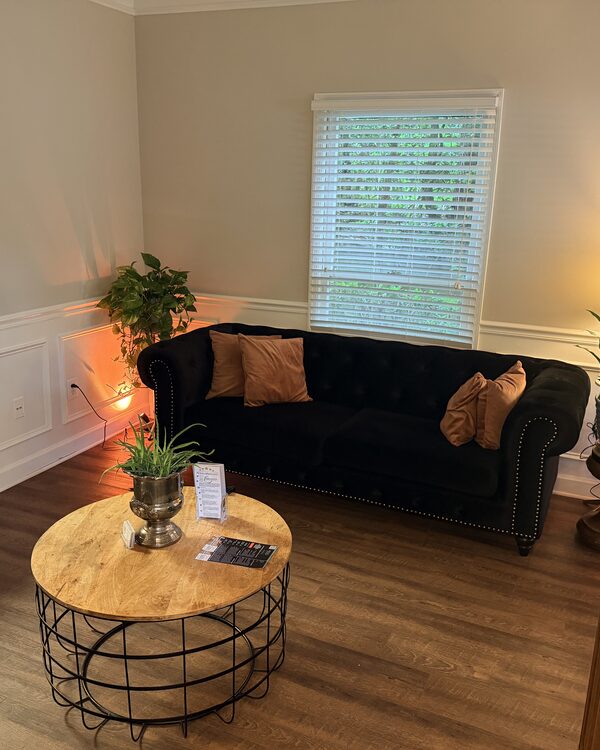 Client lounge with velvet sofa at the new Athens studio